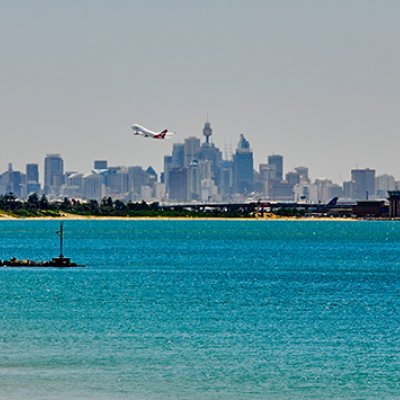 A plane taking-off over water.
